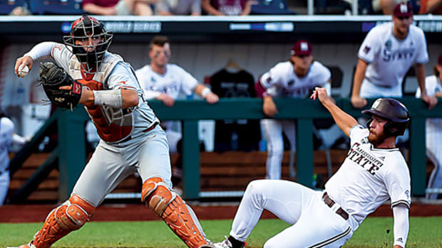 Texas Longhorns catcher Silas Ardoin (4) forces out Mississippi State Bulldogs catcher Luke Hancock (20) at home in the sixth inning at TD Ameritrade Park.